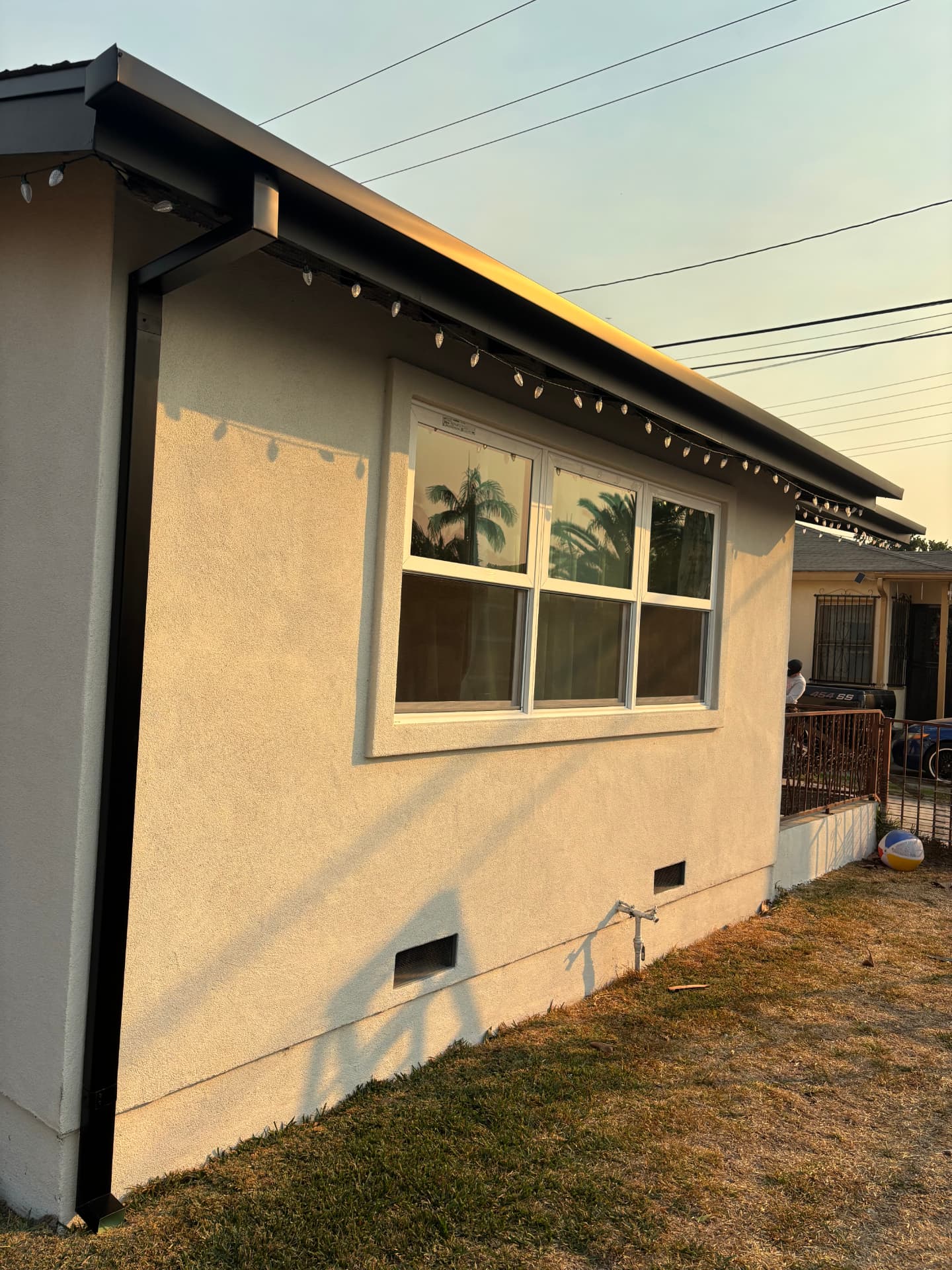Black seamless gutter installed along a home